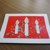Candles on Orange: white candles over a speckled orange canvas.