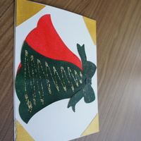 Holiday Bells: red and green bells, tied with a green bow, on a white canvas with golden corners.