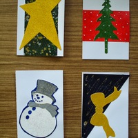Holiday Gift Tags A: Golden star on speckled black field; green pine tree on red field; snowman; golden bow on diagonal dark field.