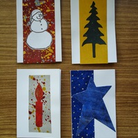 Holiday Gift Tags E: white snowman on speckled red field; green pine tree on golden field; red candle on speckled silver field; blue star on blue field.