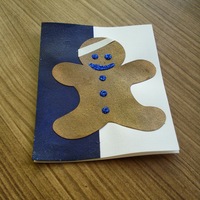 Holiday Gingerbread Man: gingerblead man with head bandage on partial blue field.