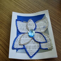 Holiday Magnolia Blue & Silver: Blue & silver glitter flower, with sheet music interior and plastic gemstone centre.