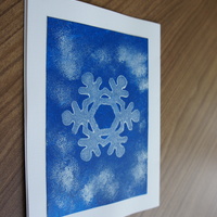 Snowflake Stamp Blue: Stamped snowflake on snowy blue field.