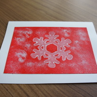 Snowflake Stamp Red: Stamped snowflake on snowy red field.